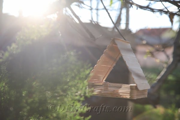 Your craft stick DIY bird feeder will look great anywhere.